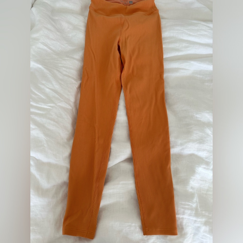 Barry’s Bootcamp peachy/orange ribbed leggings.